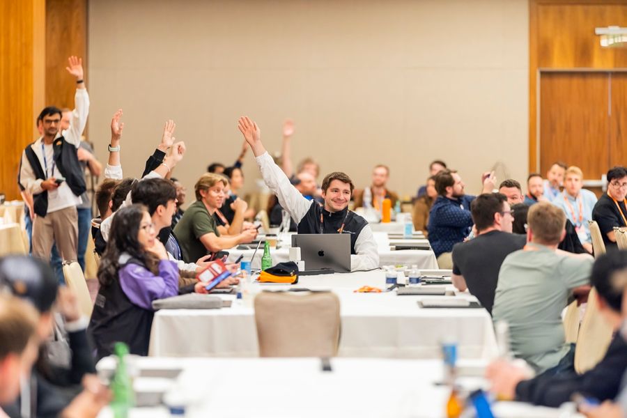Attendees raising their hands during a technical breakout at Cloudflare Connect 2025